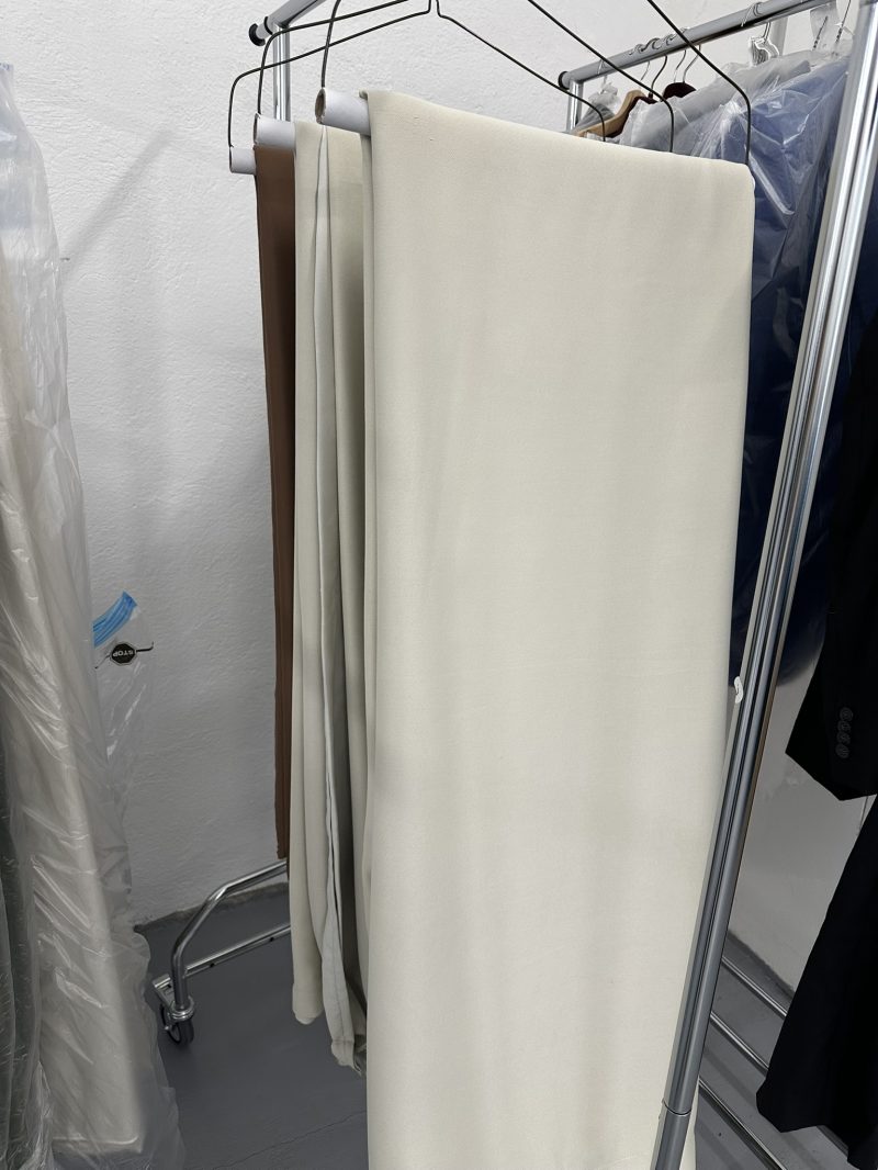 Draperii albe curatate si pregătite pe umerașe